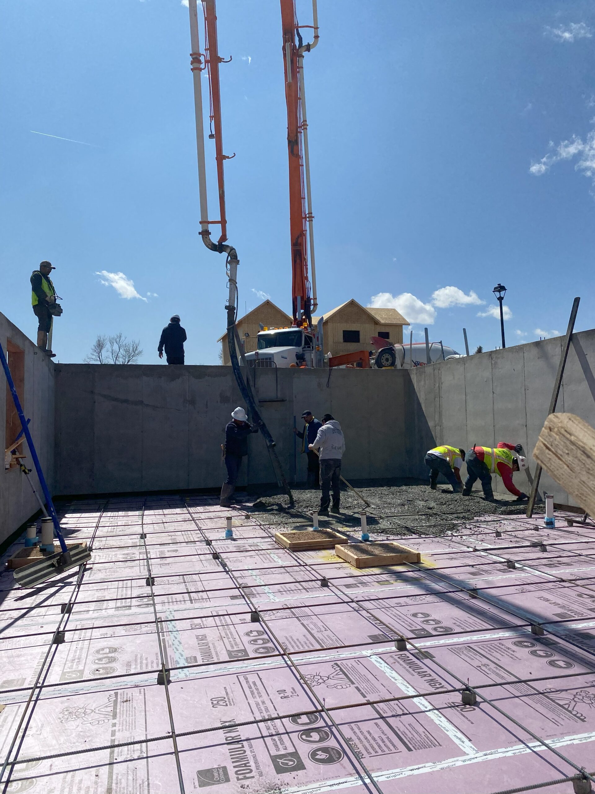 Workers Pouring Slab Over Insulation Rebar
